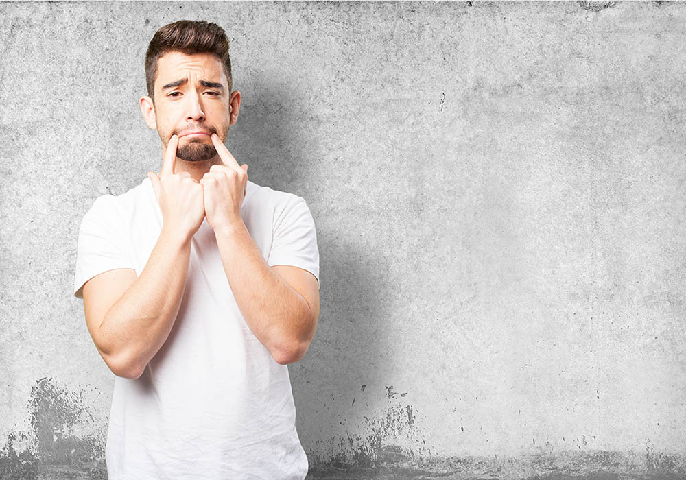 man-with-sad-face-two-fingers-his-lips-dental-dost-dental-blog