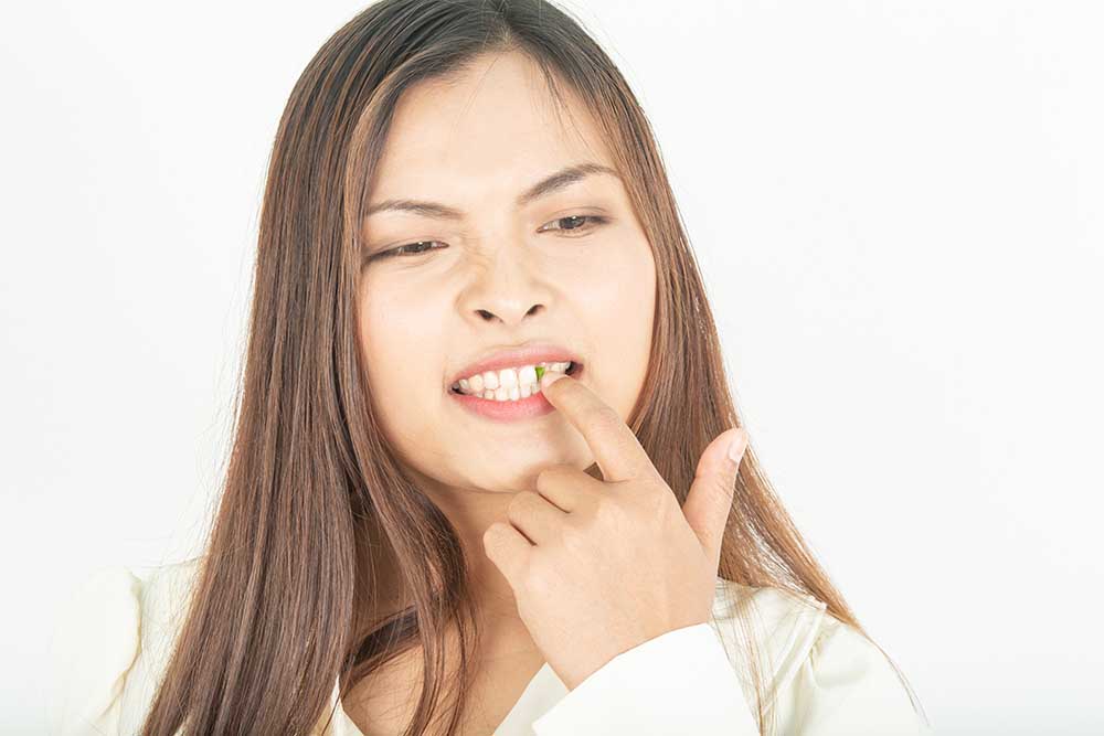 7 Ways To Avoid Getting Food Stuck In Your Teeth