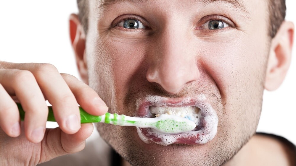 Teeth brushing man